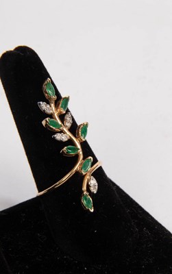 Lot 36 - A modern diamond and emerald set ring modelled...