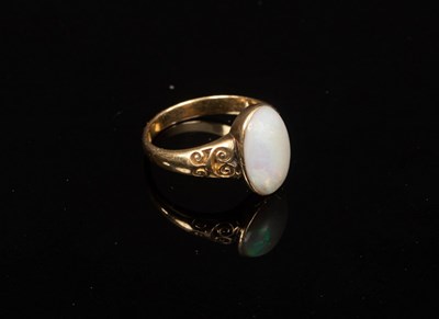 Lot 38 - An opal set dress ring, the oval stone in an...