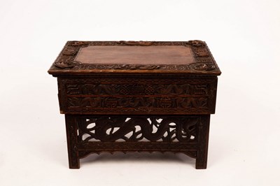 Lot 437 - A Tibetan carved prayer table with hinged top,...