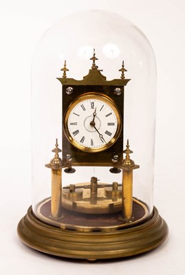 Lot 512 - A brass torsion clock, the 2'' white enamel...