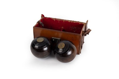 Lot 548 - Two bowling woods in a fitted leather case,...