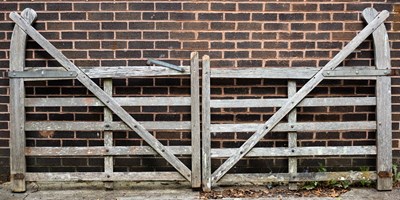 Lot 600 - A pair of five-bar cranked teak gates with...