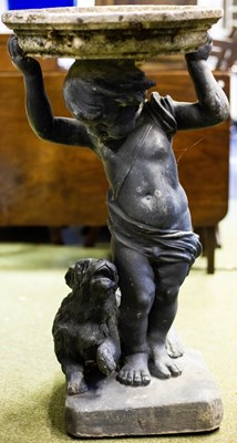 Lot 607 - A bird bath with lead putto and dog base, 76cm...