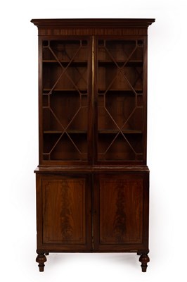 Lot 634 - A mahogany bookcase enclosed by a pair of...