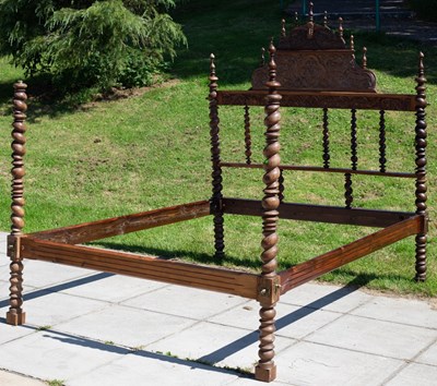 Lot 642 - A Portuguese walnut bed, the headboard with...