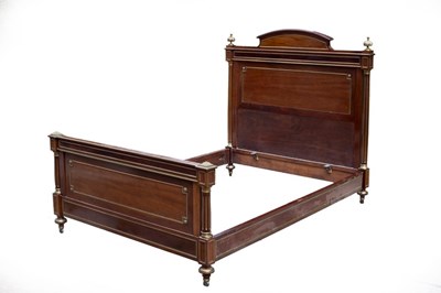 Lot 663 - An Empire mahogany parcel gilt bed with turned...