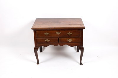 Lot 699 - A George III oak lowboy with rectangular top...