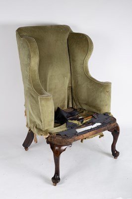 Lot 719 - A George II walnut framed wing armchair in...