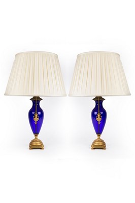 Lot 838 - A pair of blue glass vase-shaped table lights,...