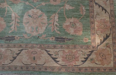 Lot 852 - A rug of Persian design, the lime green ground...