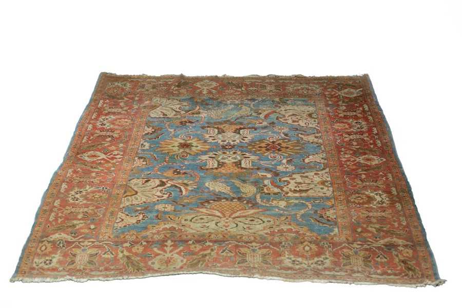Lot 856 - An Ushak Persian rug with field of birds and...