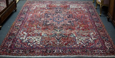 Lot 865 - A Heriz carpet of geometric design, 317.5cm x...