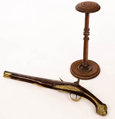 Lot 934 - A brass mounted flintlock pistol and a turned...