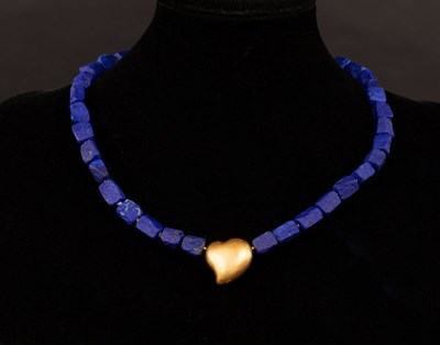 Lot 37 - A modern lapis necklace with gold heart...