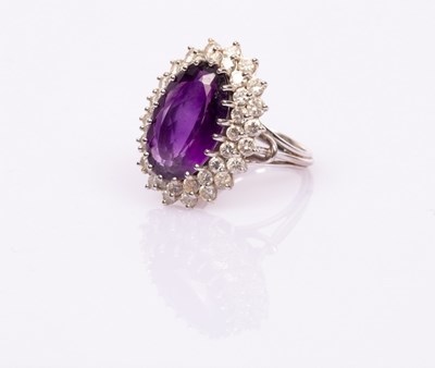 Lot 3 - An amethyst and diamond oval cluster ring, the...