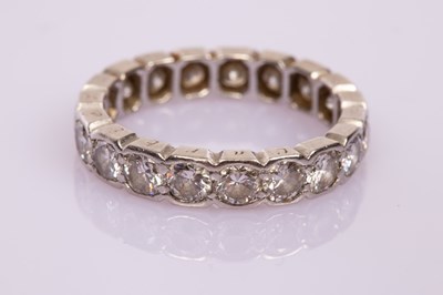 Lot 19 - A diamond eternity ring, the nineteen stones...