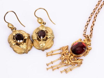 Lot 32 - A garnet and 9ct gold pendant necklace on a...