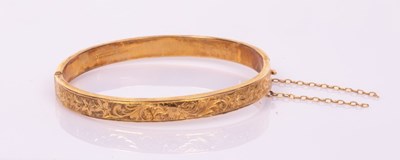 Lot 43 - A 9ct yellow gold hinged bangle, one half...