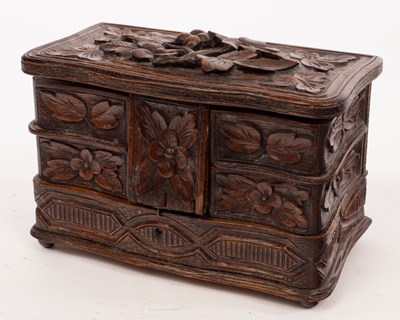Lot 45 - A carved oak jewel box with fitted interior,...