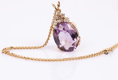 Lot 56 - An amethyst and diamond pendant, the oval pale...