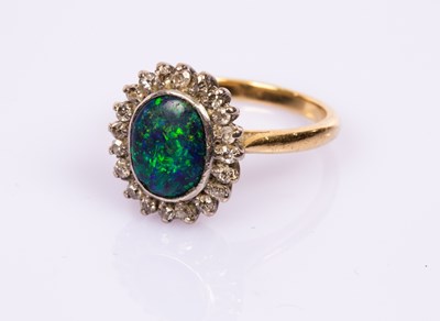 Lot 78 - A black opal and diamond cluster ring, the...