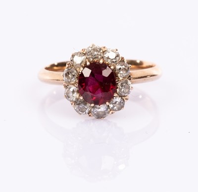 Lot 82 - A ruby and diamond cluster ring, the central...