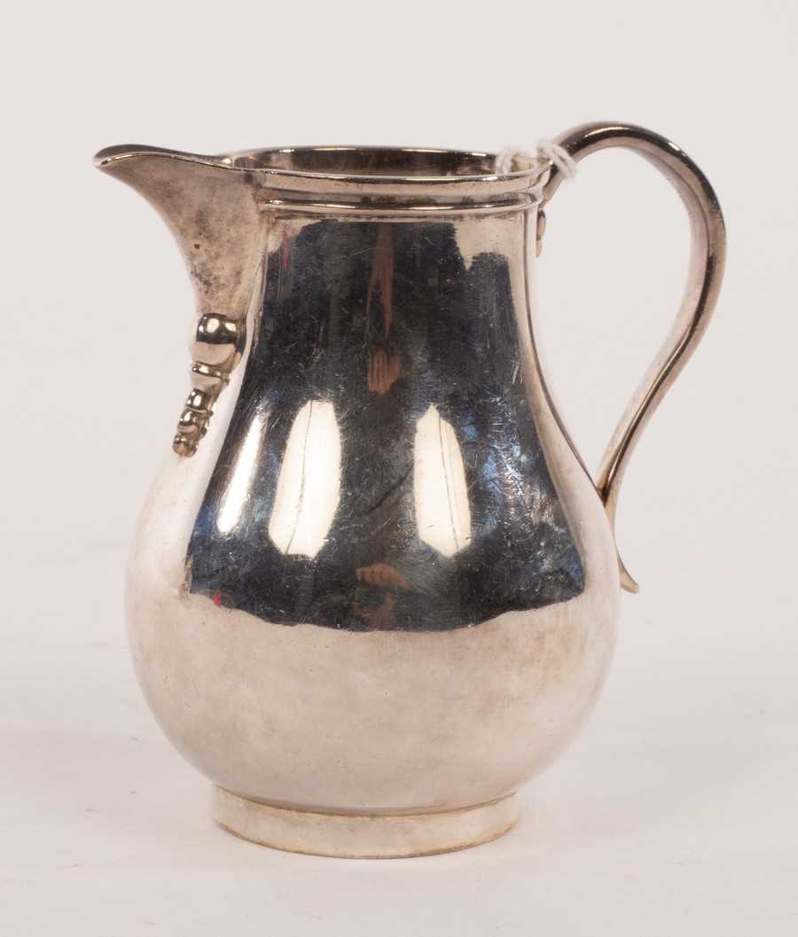 Lot 136 - A silver pear-shape cream jug, Arthur Martin...