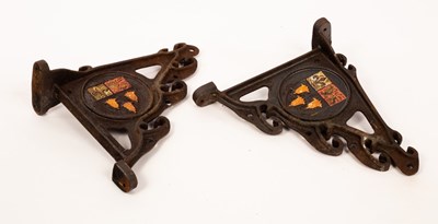 Lot 319 - A pair of cast iron wall brackets, each with...