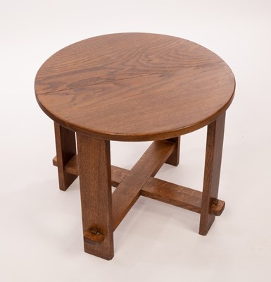 Lot 551 - An Arts & Crafts style oak table, the circular...