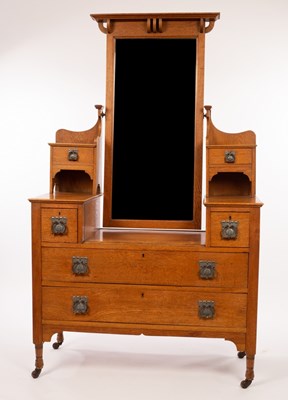 Lot 559 - An Art Nouveau oak dressing table, the mirror...