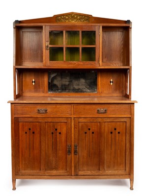 Lot 560 - An Arts and Crafts style dresser in the manner...