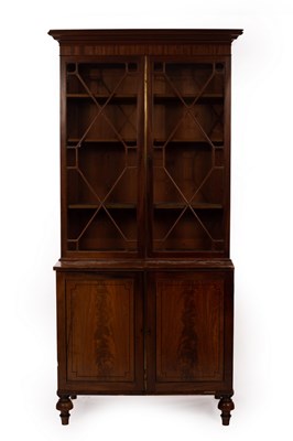 Lot 572 - A mahogany bookcase enclosed by a pair of...