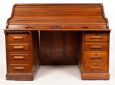 Lot 588 - An American roll top desk, fitted two banks of...