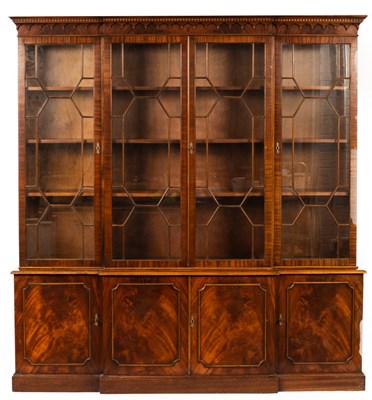 Lot 589 - A mahogany breakfront bookcase, the glazed...