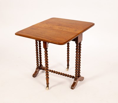 Lot 596 - A walnut oval two-flap table on bobbin turned...