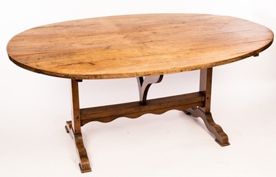 Lot 619 - A French fruitwood table, the oval tilt top on...