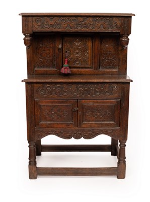 Lot 625 - A small oak court type cupboard with carved...