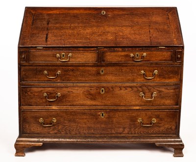 Lot 634 - A George III oak bureau, fitted beneath the...