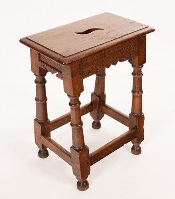 Lot 655 - An oak joint stool with pierced handle to the...