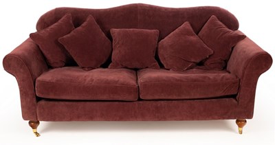 Lot 656 - An upholstered sofa covered in mauve material...