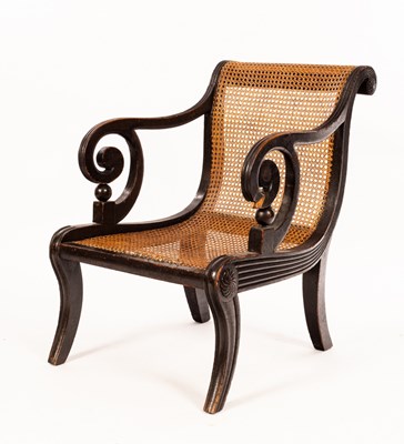 Lot 678 - A Regency ebonised library chair with cane...