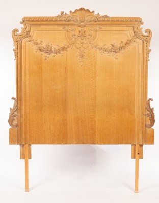 Lot 722 - A carved oak headboard, the gadrooned crest...