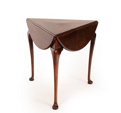 Lot 730 - A George II three-legged oak drop leaf table...