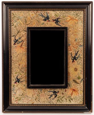 Lot 766 - A needlework framed wall mirror, swallows...