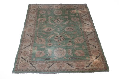 Lot 776 - A rug of Persian design, the lime green ground...