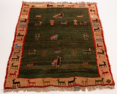 Lot 796 - A Persian Gabbeh rug, central dark green field...