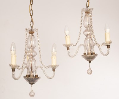 Lot 801 - A pair of cut glass three-light chandeliers...