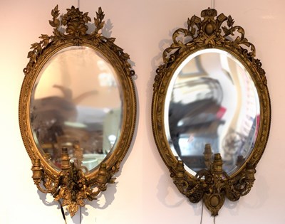 Lot 824 - A near pair of gilt framed oval girandoles,...