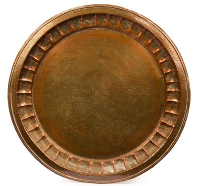 Lot 906 - A Turkish beaten copper charger, 97cm diameter