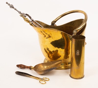 Lot 916 - A brass helmet-shaped coal scuttle with swing...